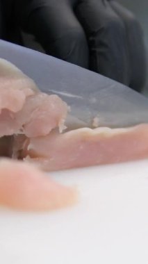 Kadınların ellerini kapat. Tavuk filetosu kes. Yemek hazırla. Tavuk eti masada. Yemek pişirmek. - Evet. Tavuk filetosunu kes.