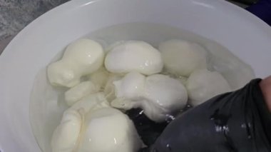 Tabakta İtalyan sert peynirli caciocavallo tutan Caciocavallo kadın elleri. Caciocavallo, Güney İtalya 'nın tipik makarna filata peyniri. Puglia malı.
