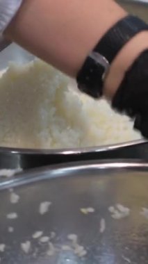 Kepli ve peynirli suşi, aşama aşama pişmiş rulo suşi. Yakından yemek pişirir. Bir şef suşi yapar ve pirinç, kırmızı balık, avokado ve Philadelphia peynirinden rulo yapar.. 