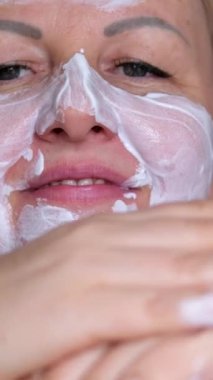 Facial mask, skincare and spa in zen wellness, luxury massage or healthcare peace room. Zoom on women or worker hands with cleaning face or skin care product in beauty salon for a relax sleep on bed.