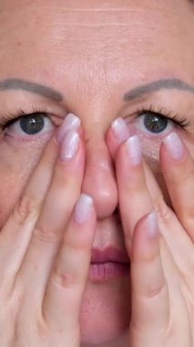 Güzel surat. Doğal makyajlı kadın yüzü. Genç ve güzel bir kadın taze nemlendirilmiş cilde dokunuyor. Deri bakımı konsepti. Yüze krem sür