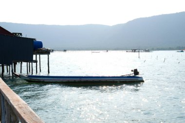 fishing village indian ocean on phu quoc island beautiful water surface fish fish farming wooden bridge house against the backdrop of extraordinary wild nature. High quality 4k footage clipart