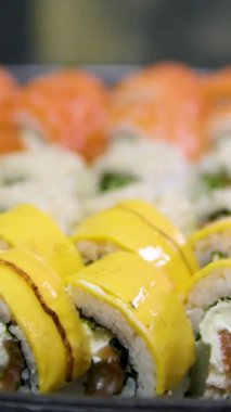 Suşi ve Japon mutfağı. Siyah arka planda beyaz sos. Yüksek kalite 4k görüntü