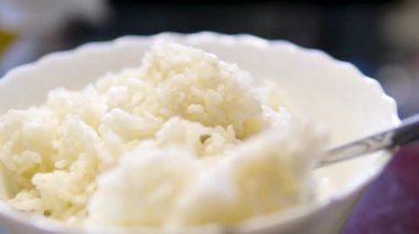 Sıcak beyaz pilav buhar kasesi mutfak arka plan paraziti. Pişirdikten sonra yapışkan pirinç. Asya Çin Tayland Japon geleneksel Hint yemekleri. Huzurlu ev yemeği gurmesi. Yüksek kalite 4k görüntü