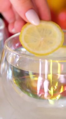 Limon sıkmak için limon suyu. Bambu köşkünde sağlıklı bir içecek için. Bitki çayı, çay demleme, açık mutfak, sağlıklı yemek, sağlıklı içecek. limonlu su