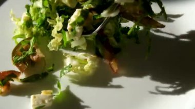 Büyük yeşil kase sağlıklı sebze salatası. Ağır çekim. Gölgeler. Domates, ahşap masa.