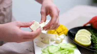 Salata doğrayan kadın mozarella peyniri salatalık domates ıstakoz sebzesi. Yüksek kalite 4k görüntü