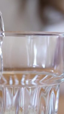 Seramik sürahiden cama temiz su dökmek, limon sıkacağı, kırsal yüzey yakınında oturmak. Ev yapımı limonata 45 'lik görüntülerden taze limon suyu elde etme kavramı