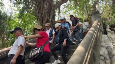 Turist gezileri farklı uluslara rehberlik eder. İnsanlar Mermer Dağ 'daki Budist tapınağını gezer. Buda tapınağının girişinin önünde. Da Nang, Vietnam 04.10.2025