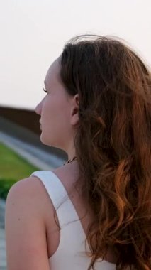 Uzun saçlı, temiz hava soluyan, derin nefes alan ve stresi azaltan güzel bir kadının portresi. Yüksek kaliteli FullHD görüntüler
