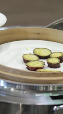 Tatlı patates büfesi dilimi ve ahşap açık büfe adam tatlı patates yuca kökü seçiyor. Yüksek kalite 4k görüntü