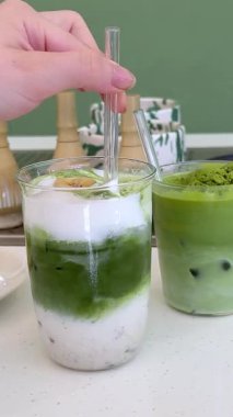 İçecekler ve tatlılar yeşil kibritli peynirli kek milkshake dondurması ve buzlu içecek gerçek bir kahve dükkanında doğru içeceklerin hazırlandığı yerde. Yüksek kalite 4k görüntü