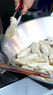 Asya 'da, Chengdu, Sichuan' da kalamar kızartma. Popüler Sokak Atıştırması. Çin sokak yemekleri. Sokak Barbeküsü. Asya yemekleri. Asya mutfağı. Yavaş Çekimde Kalamar Kızartılıyor, Yakın Çekim Görünümü. Yüksek kalite 4k görüntü