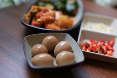 Çin yüzyıllık yumurtaları ya da kaynayan suyun içinde çay yumurtası. Kil, kül, tuz, kireç ve pirinç kabukları karışımında ördek, tavuk ya da bıldırcın yumurtalarının korunmasıyla yapılan Çin yumurtası tabanlı mutfak yemeği.