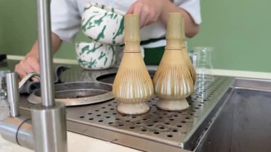 Adım adım Japon çayı yapmayı öğretiyorum. Beşinci adım, kibrit çayını bardağa dök, içkinin tadını çıkar. Yüksek kalite 4k görüntü