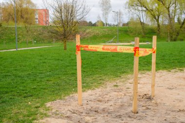 Parktaki boş çocuk parkı. Bölge turuncu bant ile çevrili..