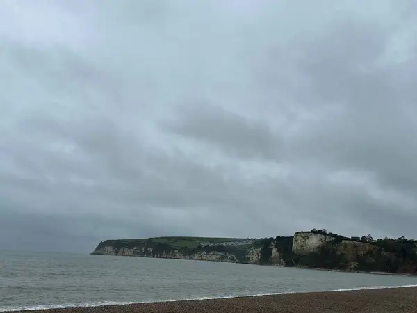 stock image A vertical shot of the sea with the cliffs in the distance