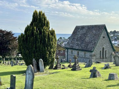 a low angle view of a church in Lyme Regis Dorset  under a blue sky on a sunny day clipart