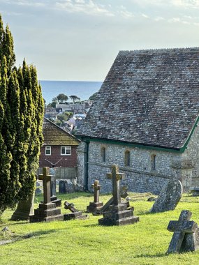 a low angle view of a church in Lyme Regis Dorset  under a blue sky on a sunny day clipart