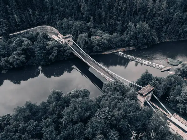 Nehir boyunca uzanan tarihi Stadlecky Zincir Köprüsü 'nün havadan görünüşü, bereketli doğa ve huzurlu manzarayla çevrili..
