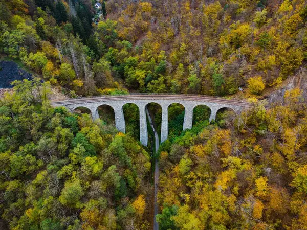 Çek Cumhuriyeti, Jilove u Prahy 'deki Zampach Demiryolu Viaduct' u. Canlı sonbahar renkleriyle çevrili tarihi taş köprünün havadan görünüşü..