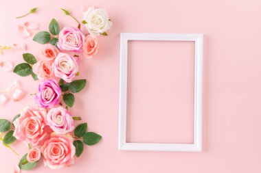Happy Women's Day decoration concept made from rose flower place around frame picture on pastel background.