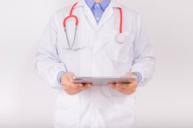 Male doctor holding modern tablet on white background for patient's health record in hospital office or clinic room