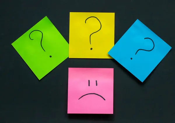 Karanlık bir arka planda soru işaretleriyle çevrili üzgün emoji, başarısız girişimler, motivasyon