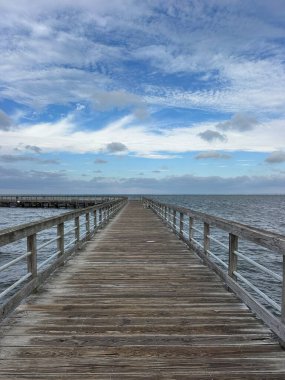 Choctawhatchee Bay pier with morning skies in the Florida panhandle  clipart