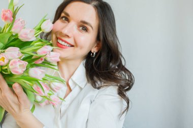 Pembe lale desenli gülümseyen genç kadın, yakından bak.