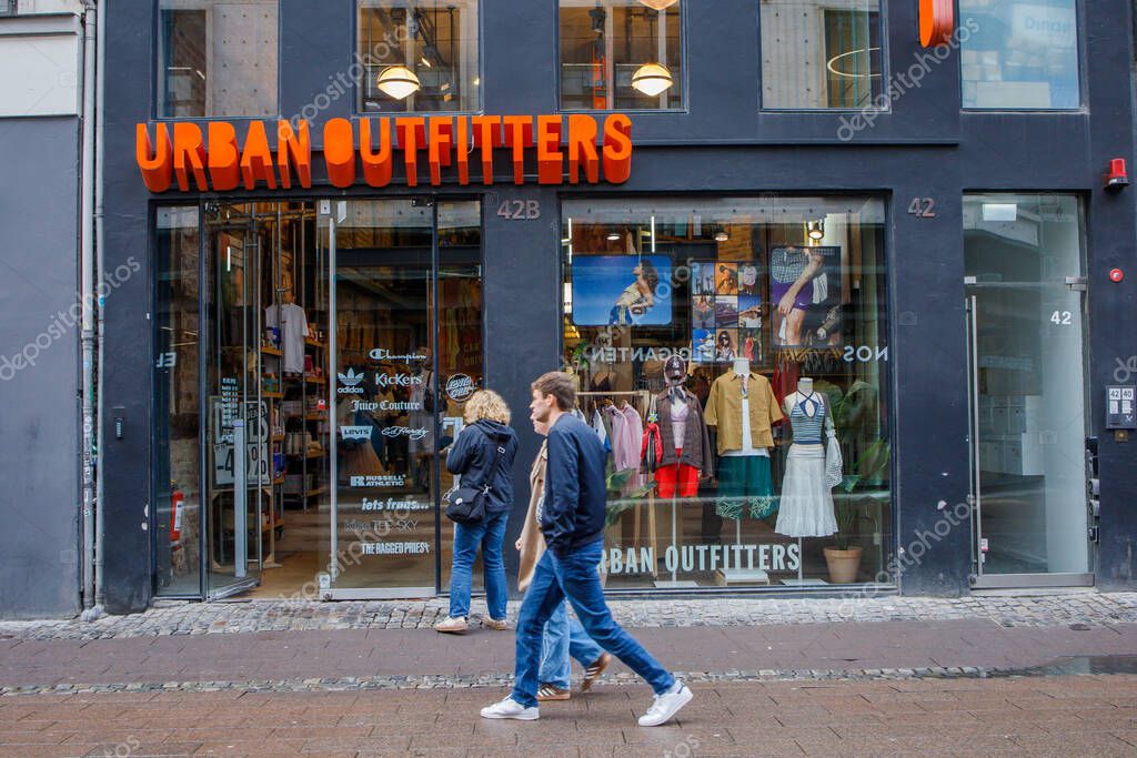 Urban outfitters clothing brand's store located in Copenhagen, Denmark city center. Entrance, showcase, logo sign and people near the shop