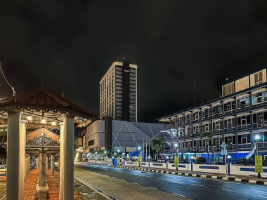 Kuantan, Malaysia - February 15 2024: A building of PKNP during night in Kuantan city with empty road clipart