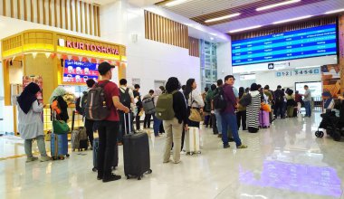 Passengers queue to check in in front of the ticket control entrance at the KCIC High Speed Rail station, Jakarta, Indonesia, August 20, 2024. Many people are queuing while carrying their belongings to go out of town. clipart