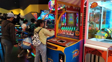 Çocuklar Timezone 'da oyun oynarken eğleniyorlar. Oyun oynayan çocuklarına bir baba eşlik ediyor. Çocuklar eğlence ve oyun mekanında heyecan verici oyunlar oynuyorlar, Timezone in Jakarta, Endonezya, 11 Ekim 2024.