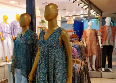 Mankenler giyim mağazasının önünde. Erkek ve kadın mankenler ITC Kuningan, Jakarta, Endonezya, 6 Ekim 2024 'te güzel ve basit Endonezya batik kıyafetleri giyerek sergileniyor..