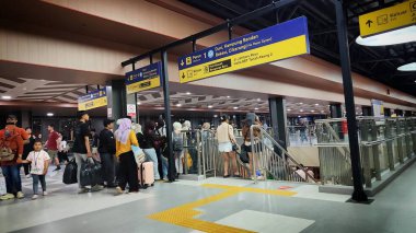 Tren yolcularından oluşan kuyruk, Tanah Abang İstasyonu 'nda tren değiştirirken yoğun bir kalabalık oluşturarak platforma iniyor. Jakarta, Endonezya, 13 Temmuz 2025.