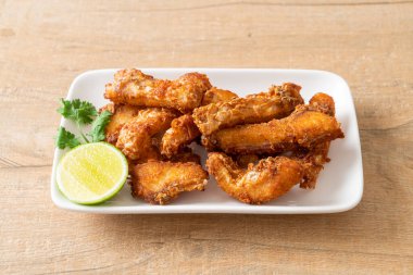 Fried Snapper Belly on white plate - Asian food style
