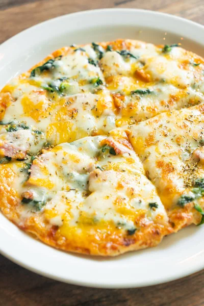 stock image spinach and bacon pizza on white plate