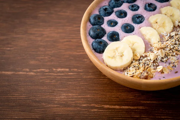 yogurt or yoghurt smoothie bowl with blue berry, banana and granola - Healthy food style