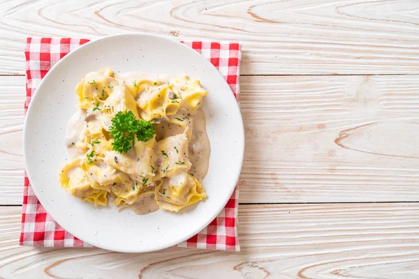 stock image tortellini pasta with mushroom cream sauce and cheese - Italian food style