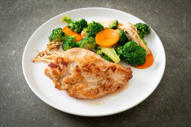 Beyaz tabakta sebzeli ızgara tavuk bifteği