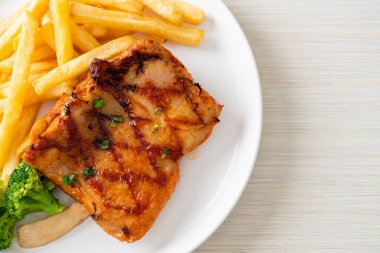 grilled chicken steak with potato chips or french fries on white plate