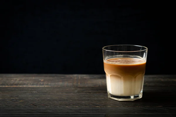 glass of latte coffee, coffee with milk on wood background