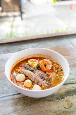 spicy seafood noodles bowl in Thai style - Tom Yum Noodles