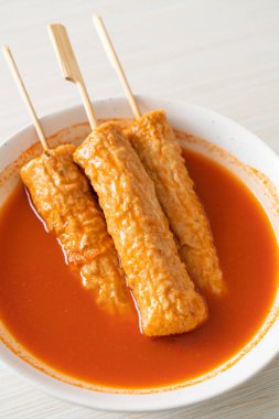 Kore usulü baharatlı çorbada Kore usulü balık köftesi şişi.