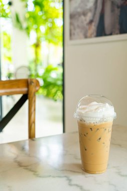 iced cappuccino coffee glass on table in coffee shop cafe