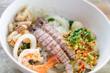 spicy seafood noodles bowl in Thai style - Tom Yum Noodles