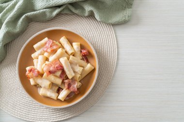 Beyaz soslu ve pastırmalı ev yapımı spagetti rigatoni makarna. İtalyan usulü.