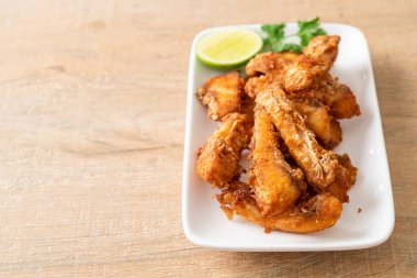 Fried Snapper Belly on white plate - Asian food style