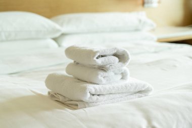close-up white towel stack on bed